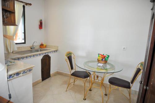 a kitchen with a table and chairs and a sink at Bali Seascape Beach Club in Candidasa