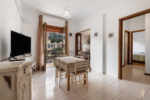 a living room with a table and a television at Casa Natalina in Recco