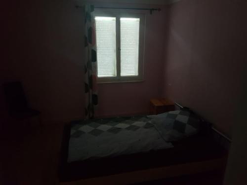 a dark room with a bed and a window at Handwerkerhaus Balaro in Weil im Schönbuch