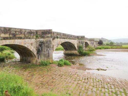 an old stone bridge over a river at The Old Cobblers in Skipton
