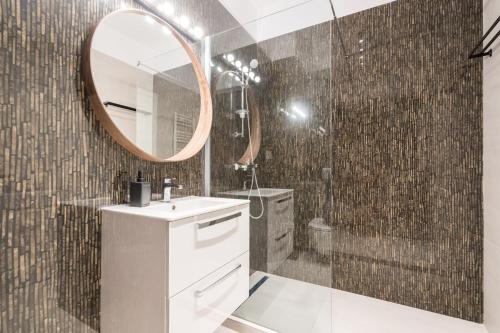 a bathroom with a sink and a mirror at ViaPipera Apartments - Modern Stay on Pipera Blvd in Bucharest