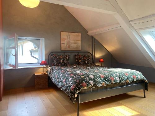 a bedroom with a bed in a attic at La Petite Campagne in Lonay