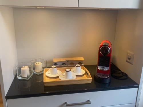 a kitchen counter with a coffee maker and candles at La Petite Campagne in Lonay