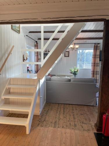 a living room with a staircase and a couch at The Soldiers house in Ekshard