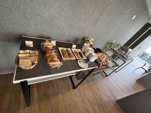 a table with a bunch of food on it at HOTEL PIEDRA SANTA - Moquegua in Moquegua