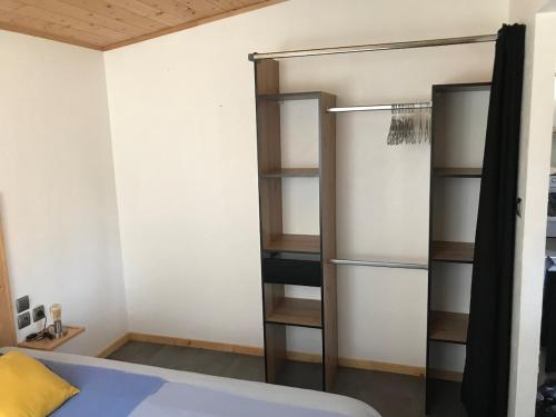 a bedroom with a bed and a book shelf at L'Accugliente in Lecci