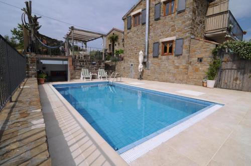 a large swimming pool in front of a building at Villa Casa Sarina in Brdo