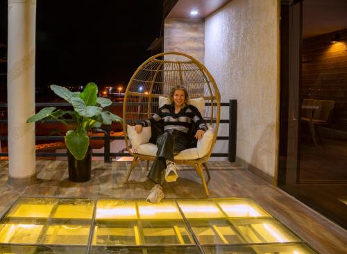 a woman sitting in a chair in a bird cage at Hotel Boutique Andina de Sal in Uyuni