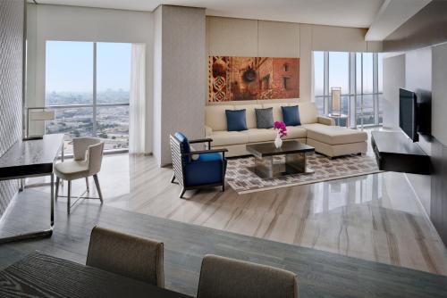a living room with a couch and a table at Hyatt Regency Creek Heights Residences in Dubai