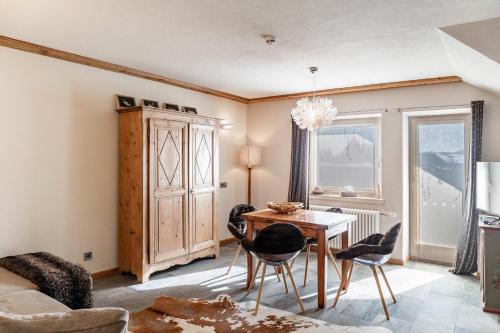 a living room with a table and chairs at Haus Gabriel - Seefeld in Seefeld in Tirol