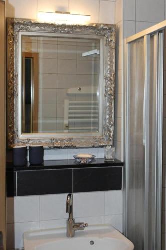 a bathroom with a sink and a mirror at Gemütliche Ferienwohnung Mit Blick Auf Die Donau in Obernzell