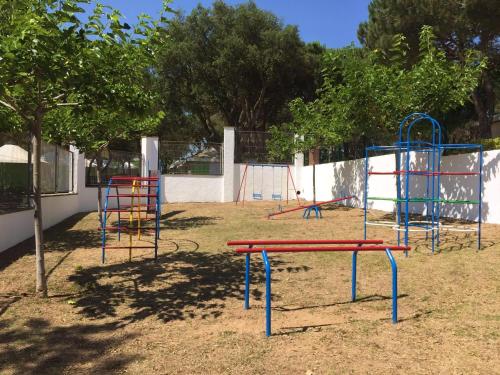 a playground with colorful equipment in a park at Costa Brava Palamos Chalettas in Palamós