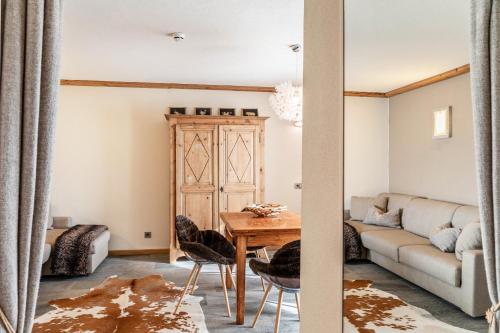 a living room with a table and a couch at Haus Gabriel - Seefeld in Seefeld in Tirol