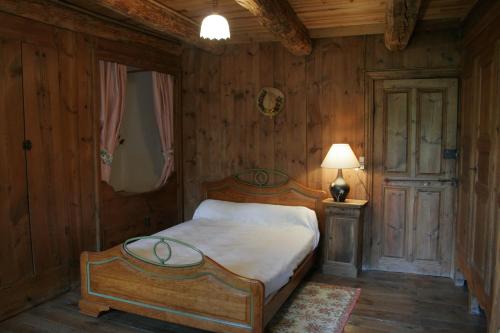 a bedroom with a bed and a lamp in it at La maison d'Anastasie in Saint-Étienne-du-Vigan