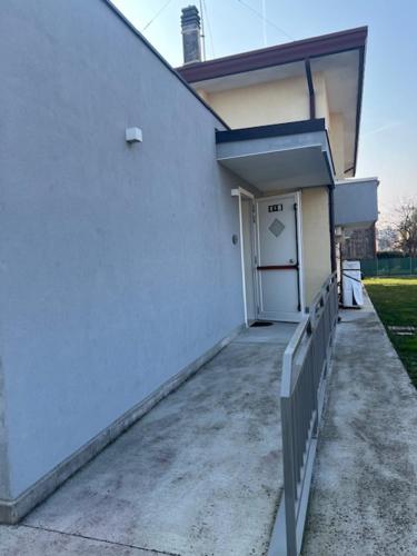 a white building with a door and a porch at Ca' Nadia in Campalto