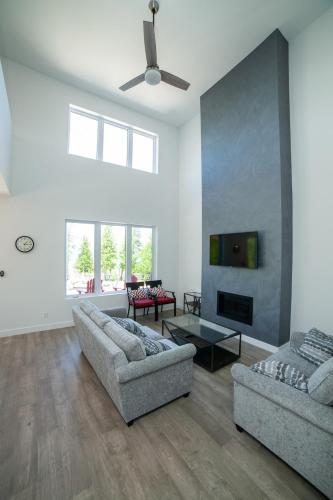 a living room with two couches and a tv at Modern Waterfront Tobermory Kayaks in Miller Lake