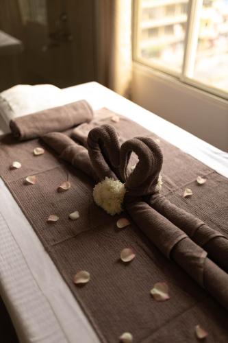 a group of towels with hearts on a bed at The Layover Hotel in Dimapur