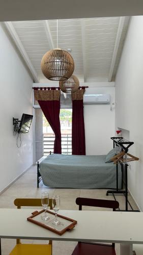 a room with a bed and a table with wine glasses at Temporario Alfonso I in Santa Fe