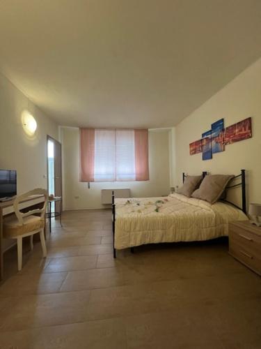 a bedroom with a bed and a table in it at Ca' Nadia in Campalto