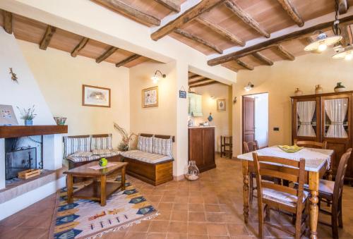 a living room with a couch and a table at Melograno Apartment Podere Giardino in Montalcino