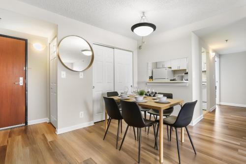 a dining room with a table and chairs and a mirror at The Perfect Stay Awaits For You in Our Apt! in Arlington