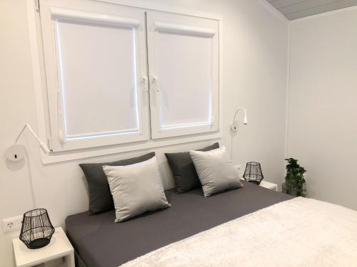 a bedroom with a large bed with two windows at Lodge Lurger Fasching In Rohrbach An Der Gölsen in Rohrbach An Der Gölsen