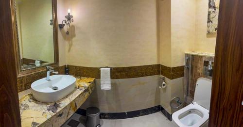 a bathroom with a sink and a toilet at IFQ Hotel & Resort Islamabad in Islamabad