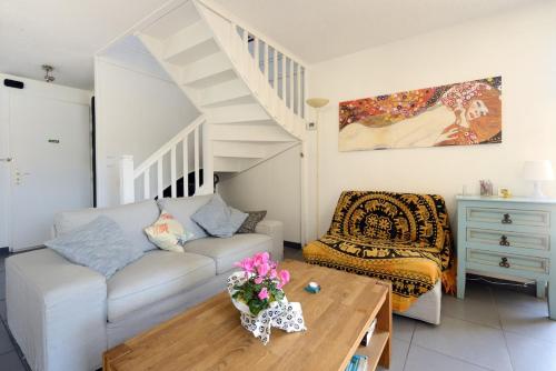 a living room with a couch and a staircase at Jolie Chambre chaleureuse in Marseille