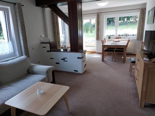 a living room with a couch and a table at Fewo Am Skihang Eg in Eibenstock
