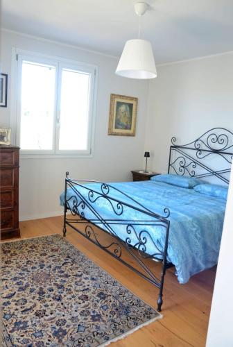 a bedroom with a bed with a blue comforter at Pane e Marmellata in Signa