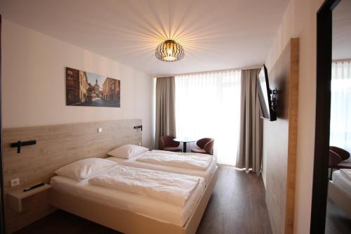 Postel nebo postele na pokoji v ubytování Das HOB - Hotel Original Bamberg
