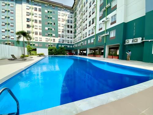 a large blue swimming pool in front of a building at Amaia Zen Near Mactan Airport in Mandaue City