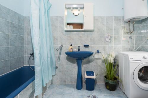 a bathroom with a blue sink and a toilet at Panoramare in Zagorje