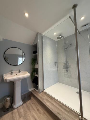 a bathroom with a shower and a sink at Field View in Lower Beeding