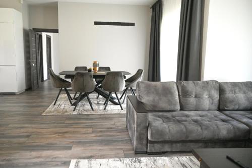 a living room with a couch and a table at Kintų Perlas Villa 4B in Kintai