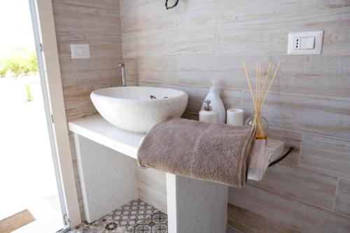 a bathroom with a white sink on a counter at Apulia Luxury Dream in Aradeo