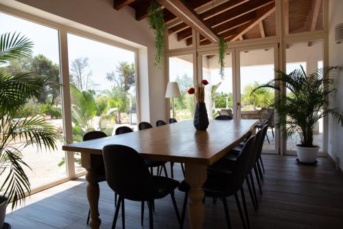 a dining room with a wooden table and chairs at Apulia Luxury Dream in Aradeo