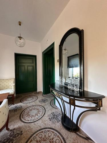 a room with a table with a mirror and a couch at Logie By Dedes in Birchiş