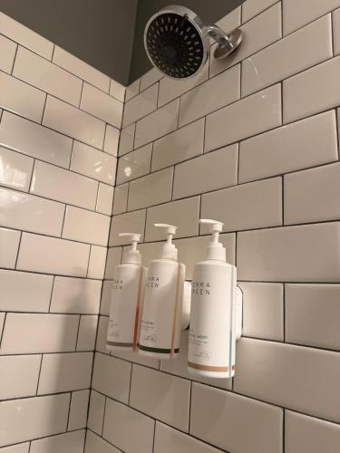 three bottles of soap on a shelf in a bathroom at The Gadsden Hotel in Douglas