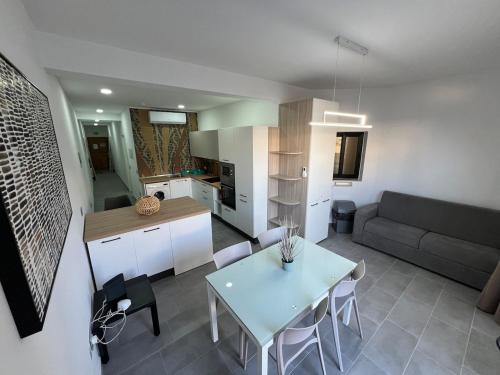 a kitchen and living room with a table and a couch at Triton Mansion D26 - Entire Unit in St. Paul's Bay