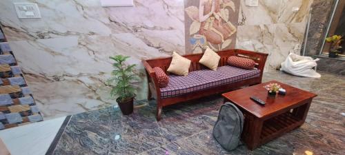 a living room with a couch and a table at Karthik Residency Thiruvannamalai in Tiruvannāmalai
