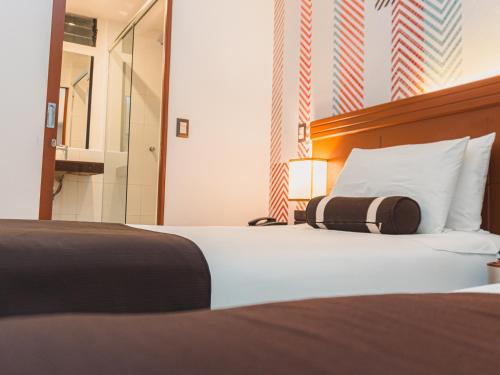 Postel nebo postele na pokoji v ubytování Hotel Ferré Machu Picchu