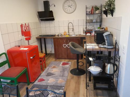 a kitchen with a counter and a red refrigerator at Ferienwohnung Auszeit in Aue