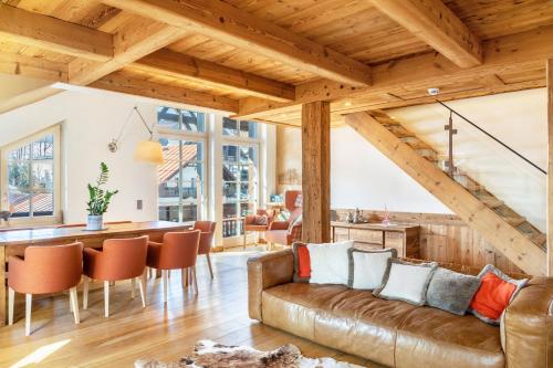 a living room with a couch and a dining room table at Haus Gabriel - Seefeld in Seefeld in Tirol