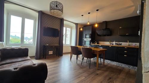 une cuisine et un salon avec une table et des chaises dans l'établissement Le Pavillon de Chasse, à Muttersholtz