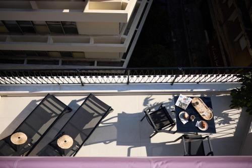 an overhead view of two chairs and a table on a balcony at AthenSun Luxury Suites in Athens