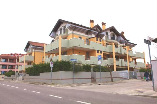 a large building on the side of a street at San Pietro D'Orio Apartment in Grado