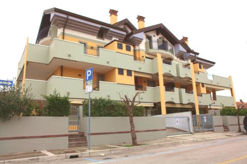 a large building on the side of a street at San Pietro D'Orio Apartment in Grado