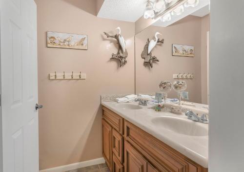 a bathroom with a sink and a mirror at Buena Vista 302 by Vacation Homes Collection in Gulf Shores