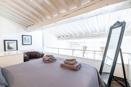 a room with a bed with two towels on it at Florence F&M Via Maggio in Florence
